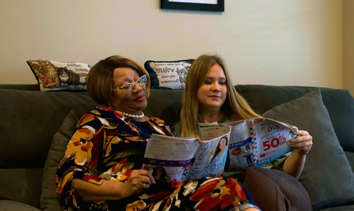 Senior resident and a younger family member relaxing together at The Abbey at Westminster Plaza