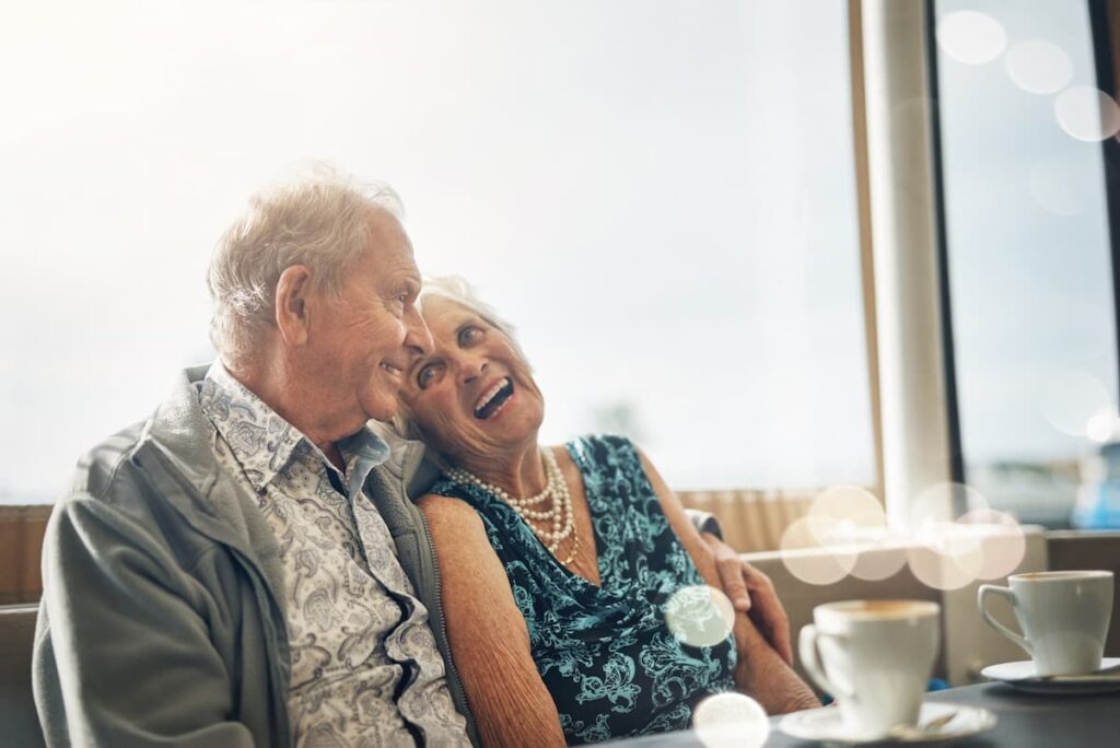 The Abbey | Senior couple laughing over coffee